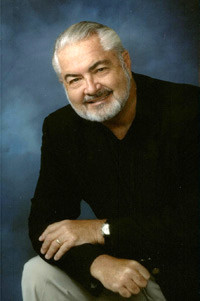 Dr. James V. Zelch a doctor at Advantage Diagnostics wearing a black jacket in front of a blue background.